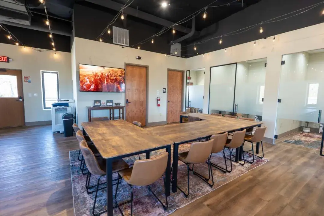 The meeting room at CoMission Lab, set with a long table for a dozen people