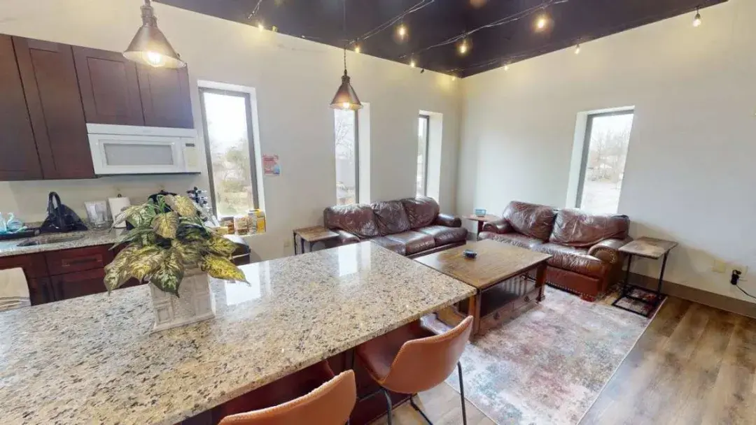 The kitchen and lounge corner at CoMission Lab, with tall windows and room to sit